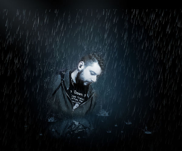 Digital composite image of man during rainfall at night