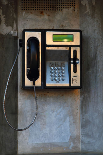 Close-up of telephone booth on wall
