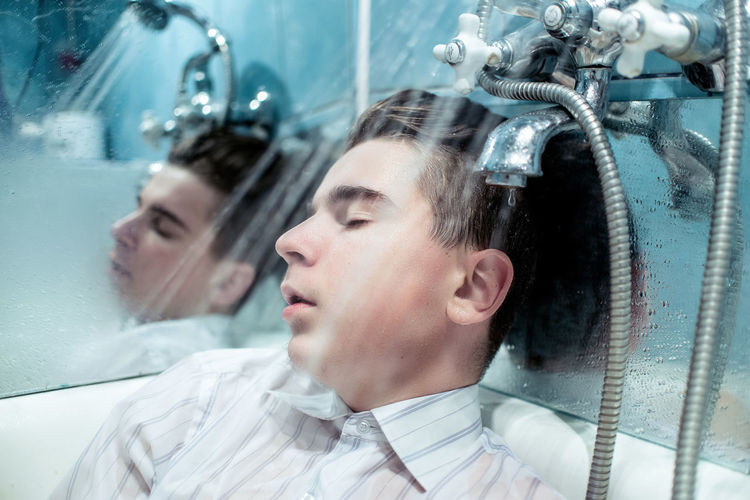 Young man in bath tub