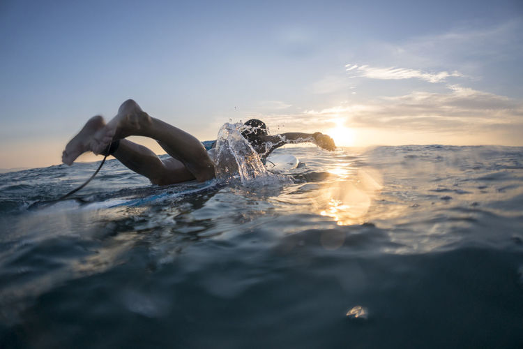 Mid twenties man surfing near punta de mita, mexico