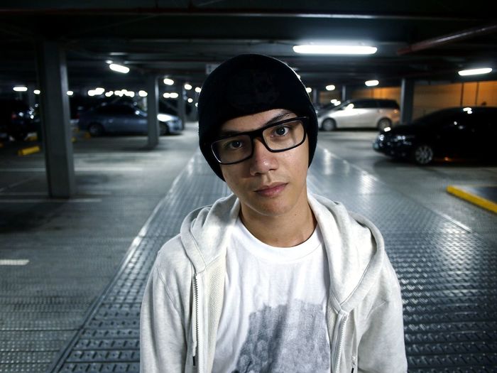 Portrait of teenage boy standing in parking lot
