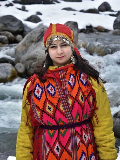 Beautiful girl in traditional wear  in snow fall in manali / india