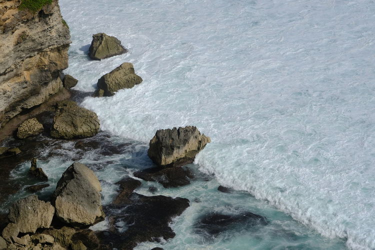 High angle view of rocks in sea