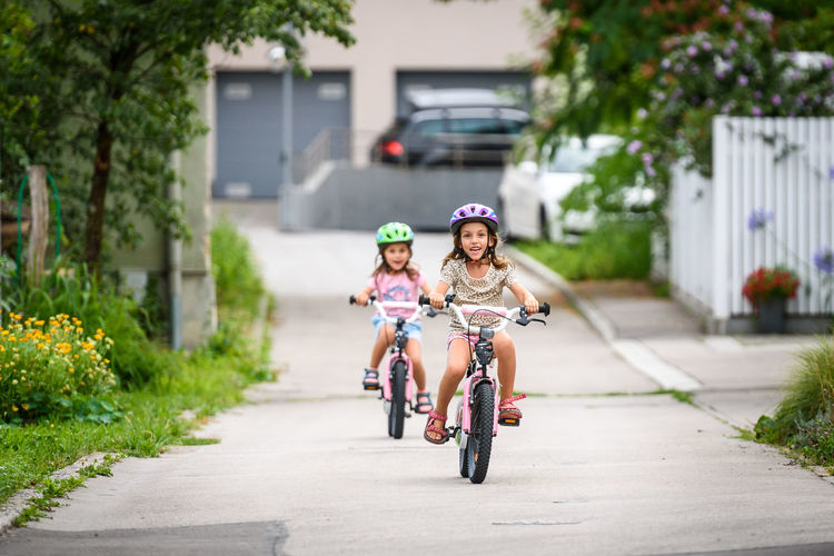 Girl riding bicycle on road