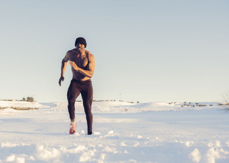 Full length of man on snowy land against sky