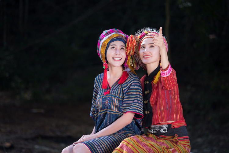 Smiling female friends wearing traditional clothing
