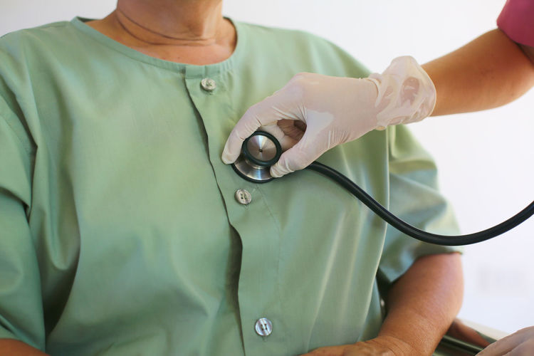 Midsection of woman holding thermometer