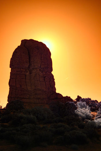 Rock formation against sky during sunset