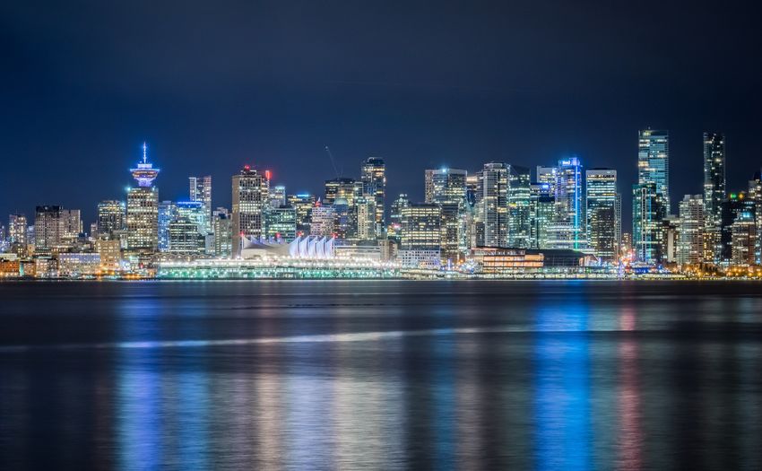 Illuminated city at waterfront