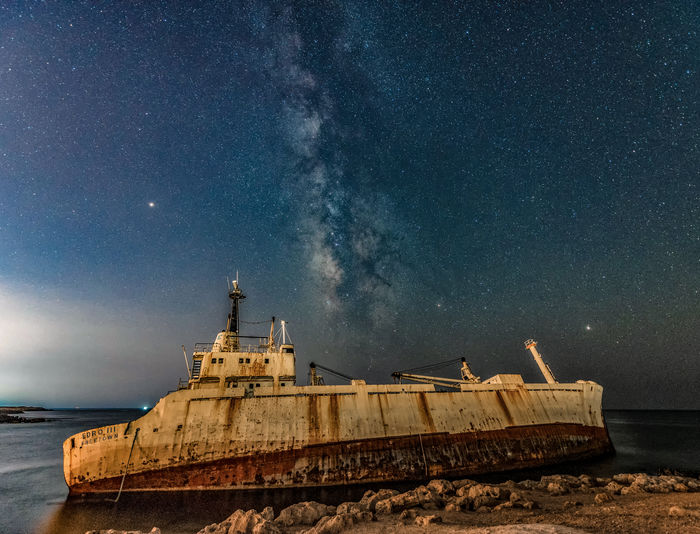 Abandoned ship on sea at night