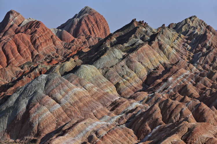 Rock formation on landscape against sky. zhangye danxia-red cloud nnal.geological park, gansu, china