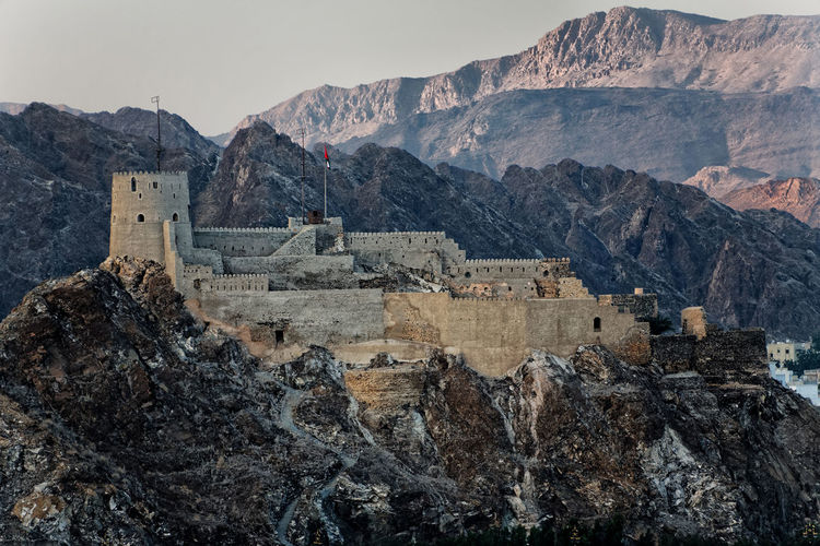 Castle against rocky mountains