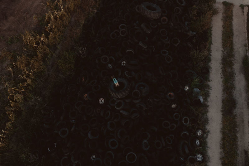 High angle view of person in tire on land