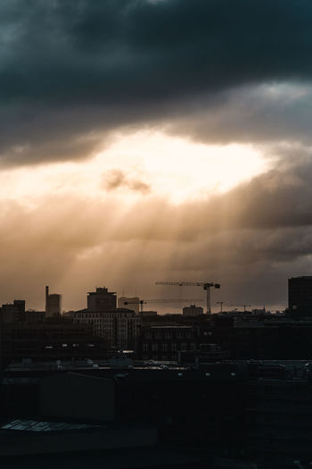 Silhouette buildings against sky during sunset