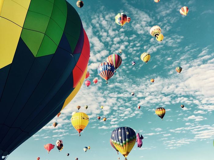 Low angle view of colorful hot air balloons against sky