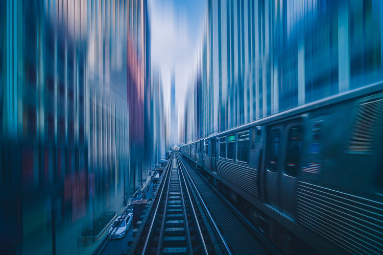 Futuristic scene motion blur movement between elevated train line over the railroad tracks