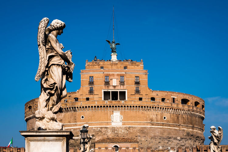 Statue of an angel carrying a cross on the sant angelo bridge in rome, italy