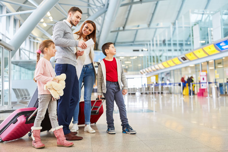Parents with children standing at airport