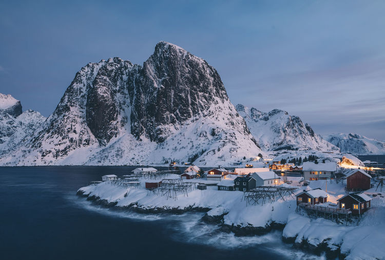 Aerial view of snowcapped mountains against sky during winter
