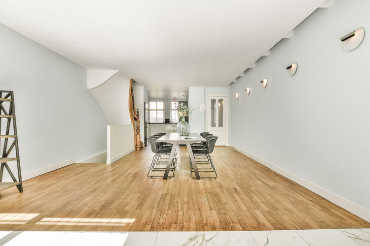 Empty chairs and tables on hardwood floor at home