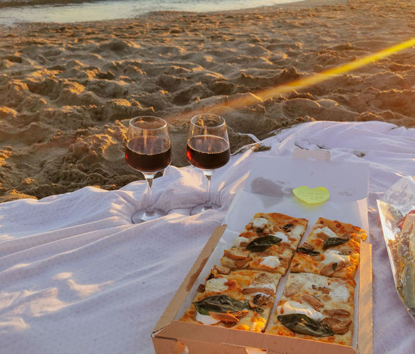 High angle view of beer on sand at beach