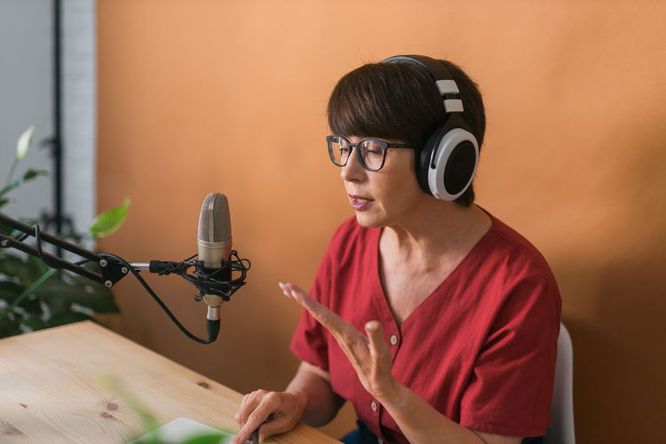 Woman podcasting at studio