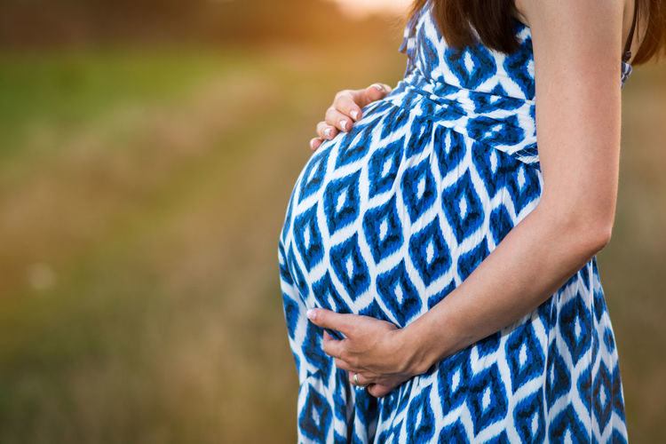 Close-up mid section of pregnant woman