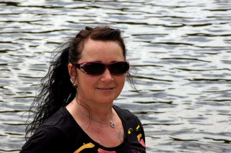 Portrait of woman wearing sunglasses in sea