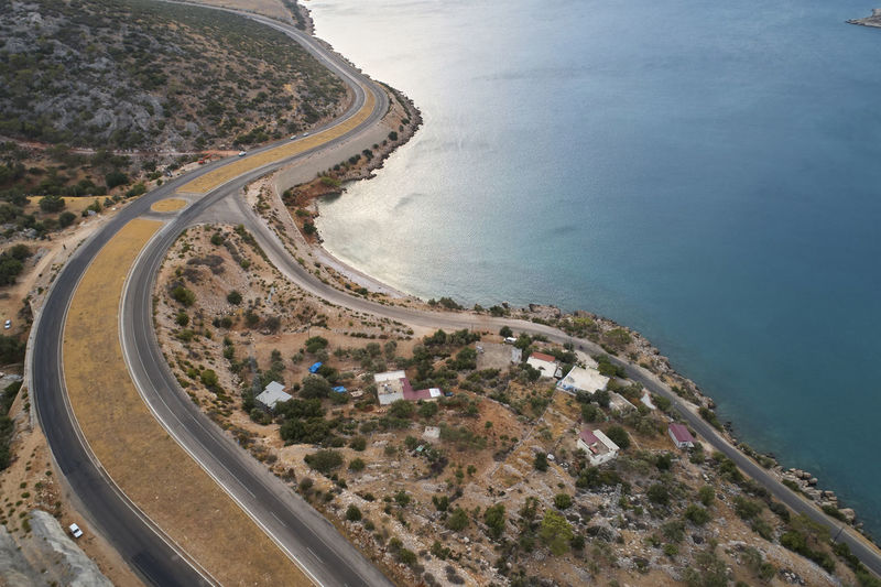 Aerial view of land by sea