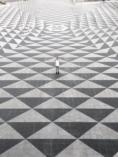High angle view of man standing on tiled floor