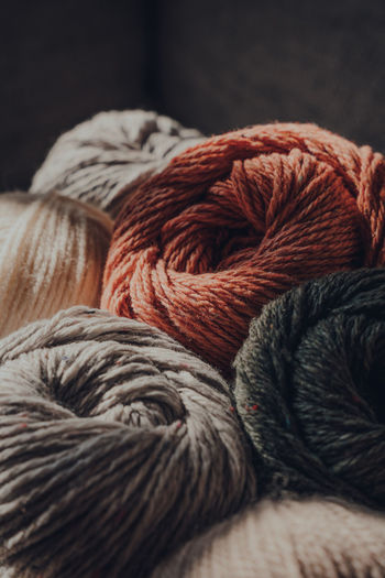 Close up of earth coloured coloured skeins of wool yarn, selective focus.