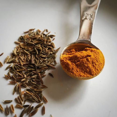 High angle view of turmeric and cumin on table