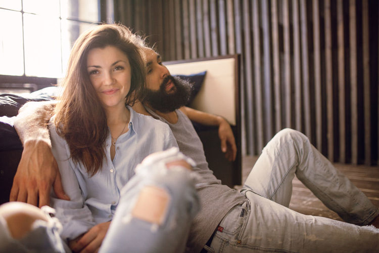 Young pretty couple having fun on bed in morning.