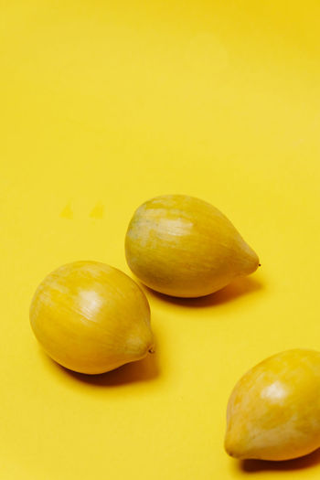 High angle view of fruits against yellow background