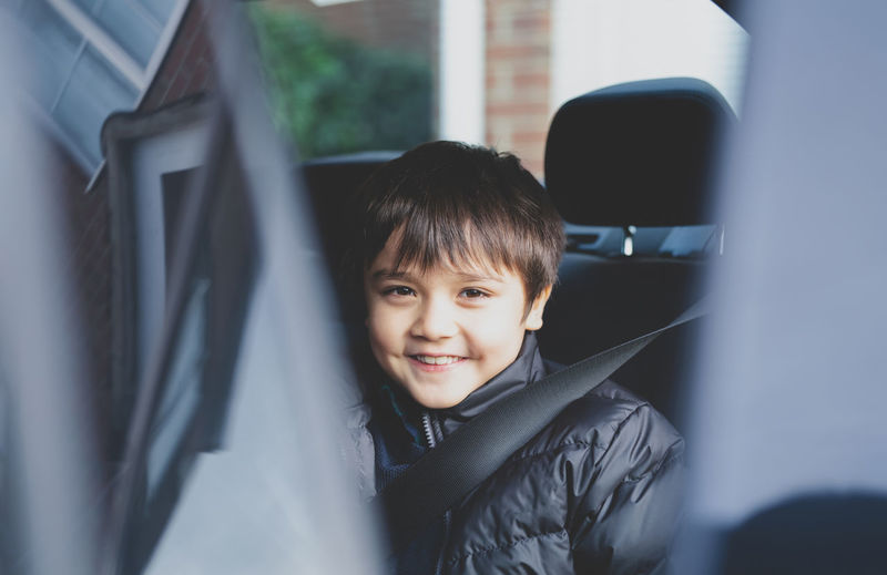 Kid sitting back seat kid siting in safety car seat,child sitting in back seat with a safety belt