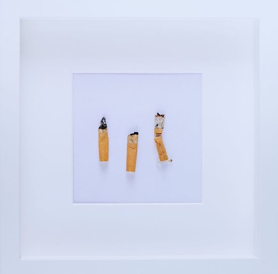 Directly above shot of cigarette with text on white background