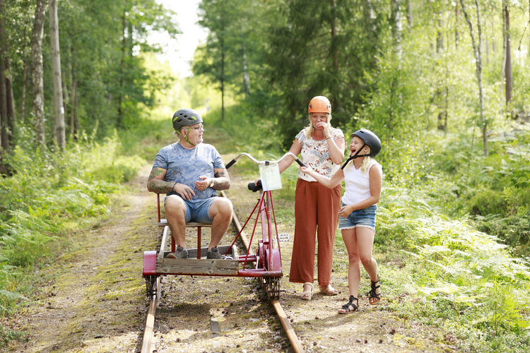 Girl with parents standing near handcar