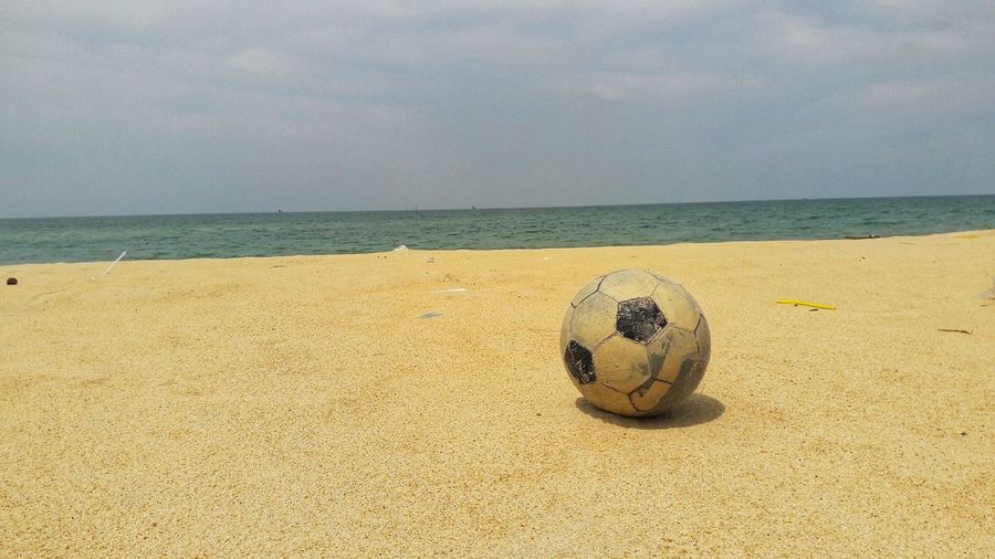 Scenic view of ball on beach against sky