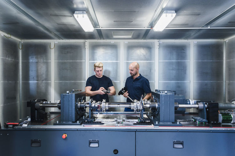 Two colleagues working in modern factory