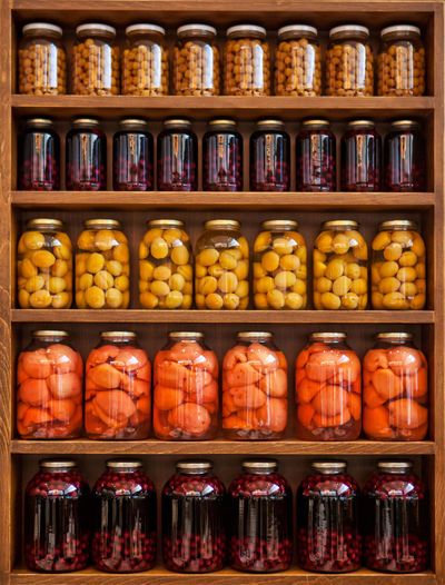 Food in jars arranged on shelf in store