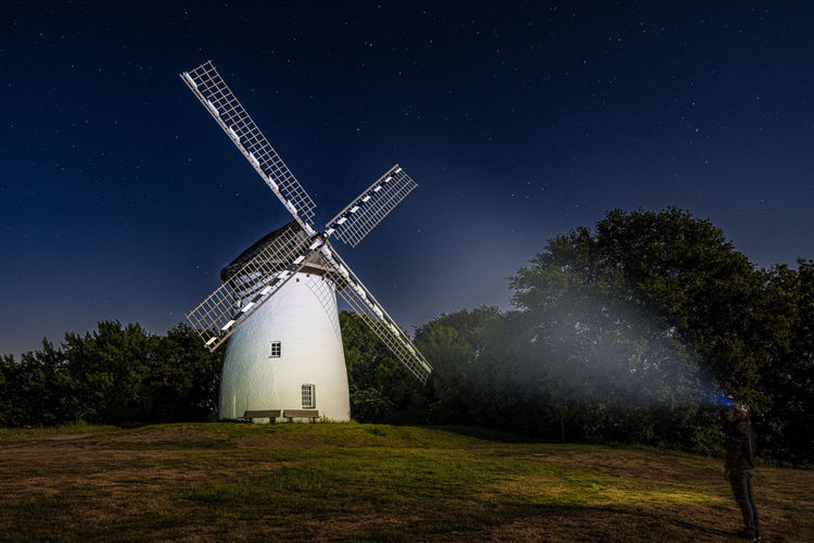 Low angle view of windmill against sky at night