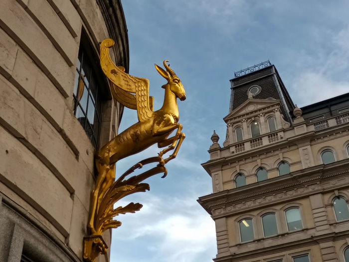 Low angle view of statue against historic building
