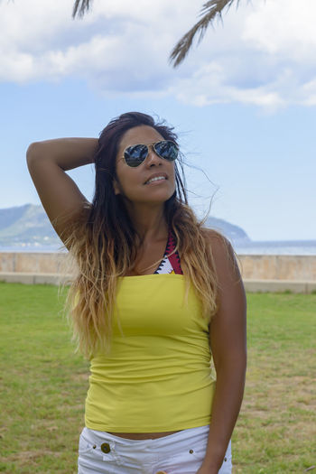 Portrait of a latin woman smiling, on vacation in mallorca posing  a summer day, vacation concept