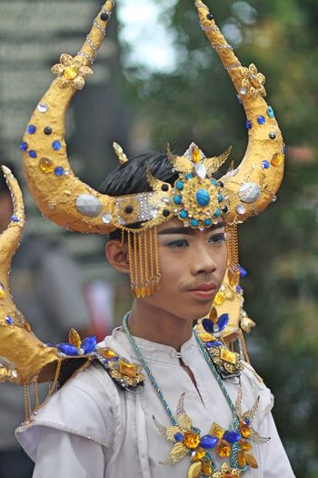 Close-up of young man wearing headdress during traditional festival