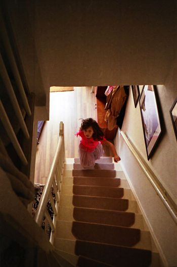 High angle view of woman standing on staircase
