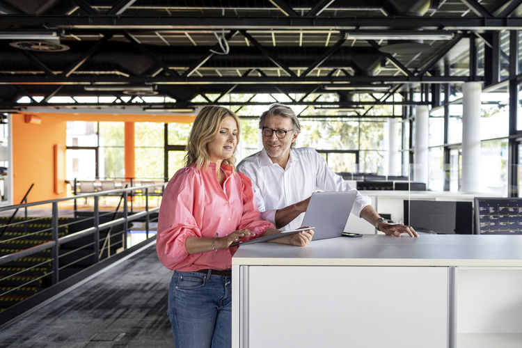 Businesswoman discussing with coworker in office