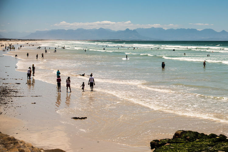 People on beach against sky
