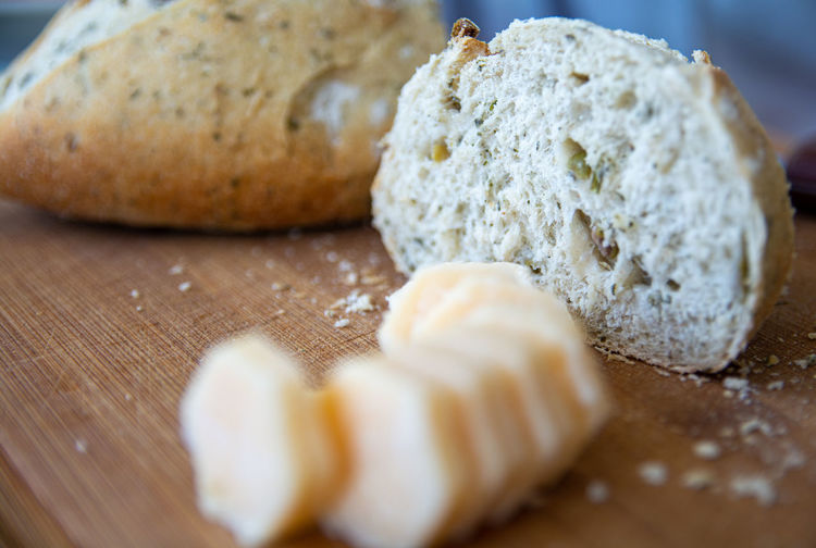 Close-up of cheese and bread on cutting board