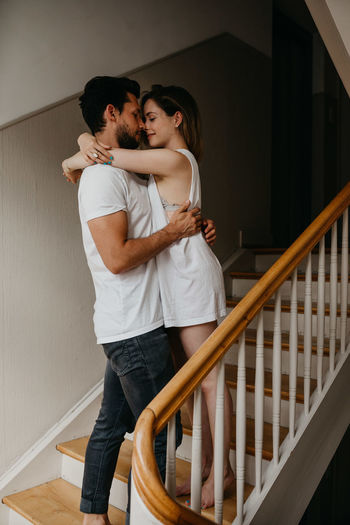 Young couple standing on staircase