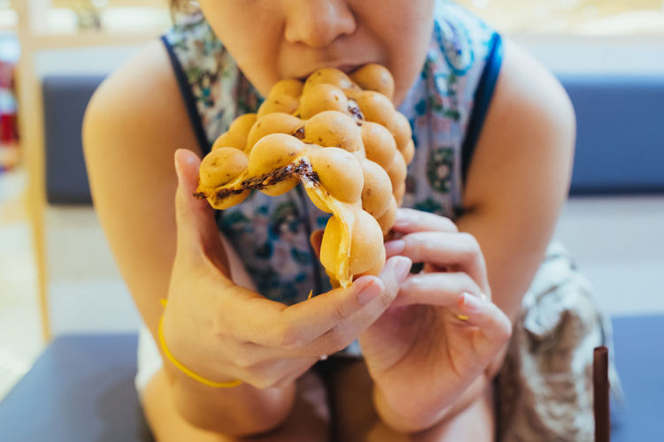 Midsection of woman eating food